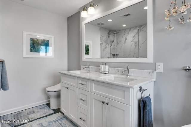 full bath featuring visible vents, a sink, a marble finish shower, and toilet