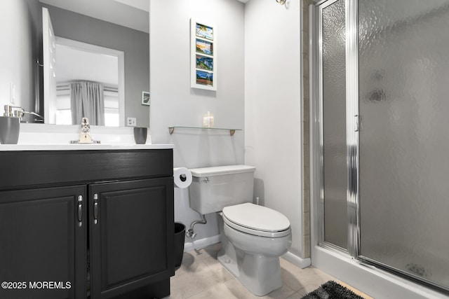 bathroom with a stall shower, tile patterned flooring, vanity, and toilet