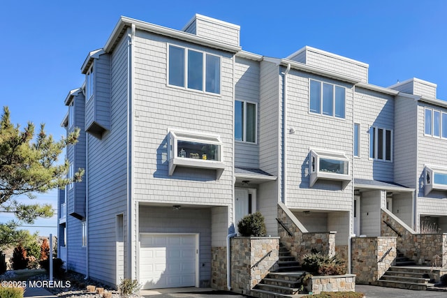 view of front of house featuring a garage and stairs