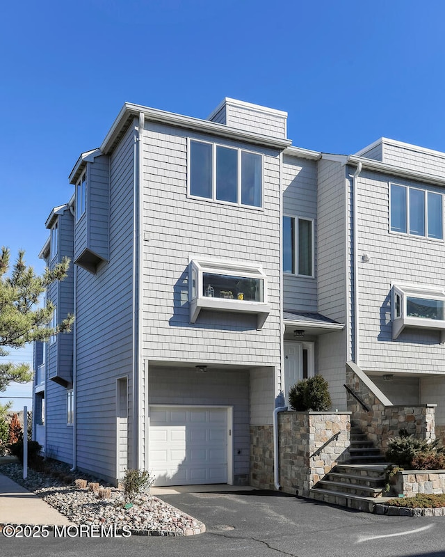 view of front facade with stairway and an attached garage