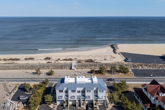 birds eye view of property with a beach view and a water view