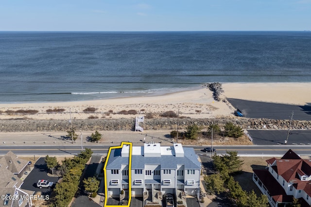 drone / aerial view featuring a view of the beach and a water view