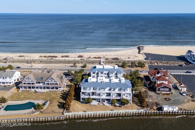 drone / aerial view with a view of the beach and a water view