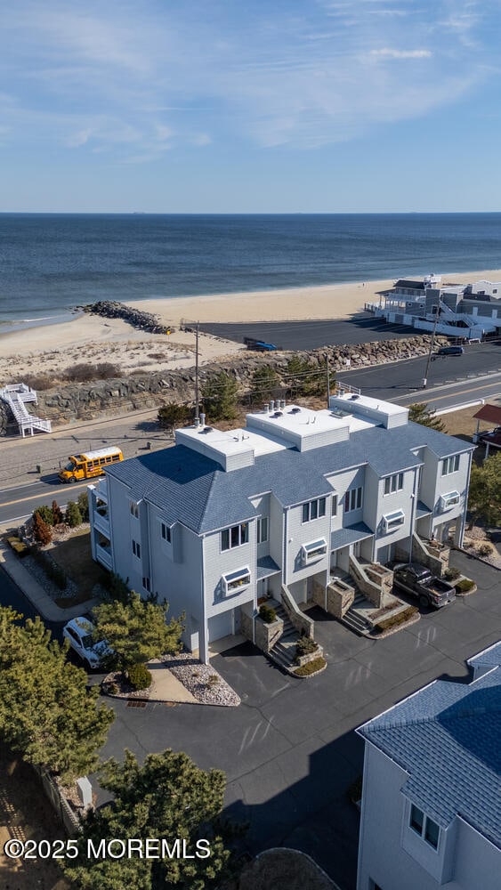 bird's eye view featuring a water view and a view of the beach