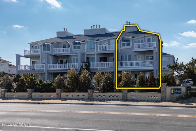 view of property with fence