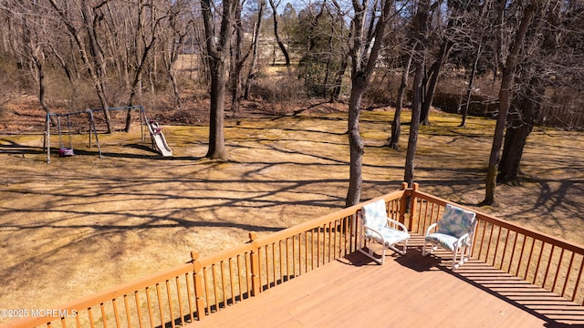 wooden terrace featuring a playground