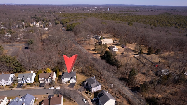 birds eye view of property with a wooded view and a residential view