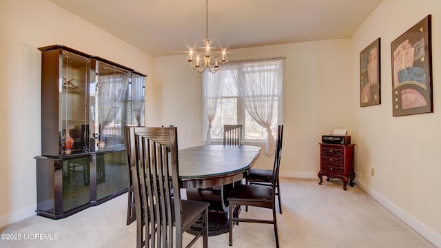 carpeted dining area with baseboards and an inviting chandelier