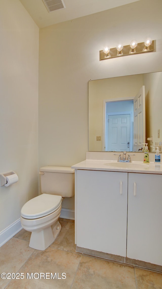 bathroom with visible vents, baseboards, vanity, and toilet