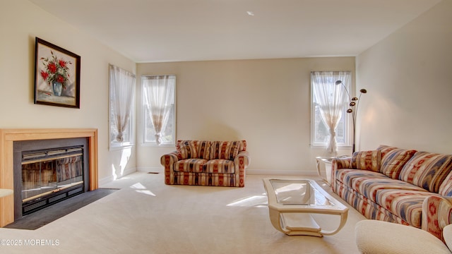 living area with carpet floors, a fireplace with flush hearth, and baseboards