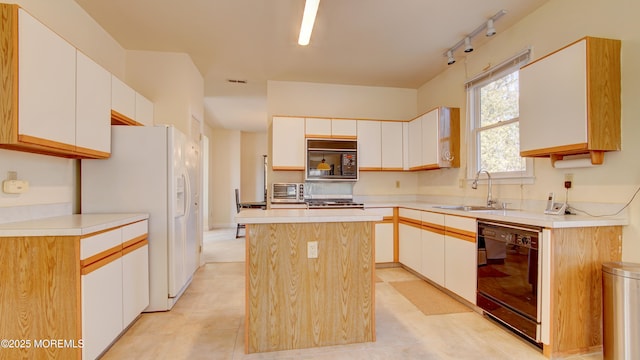 kitchen featuring black appliances, white cabinets, a sink, and a center island