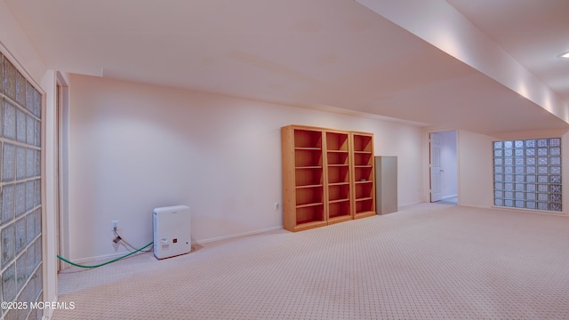 interior space with carpet and baseboards