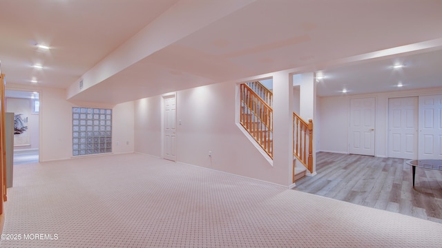 finished below grade area with stairs, carpet flooring, and recessed lighting