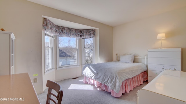 bedroom featuring light carpet, visible vents, and baseboards