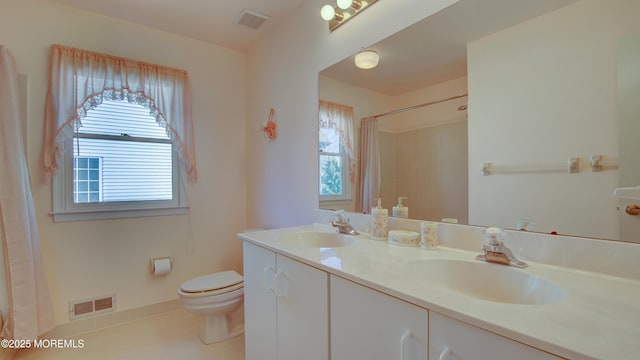 full bathroom featuring toilet, a sink, and visible vents