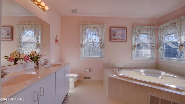 full bath with a healthy amount of sunlight, visible vents, a sink, and a bath