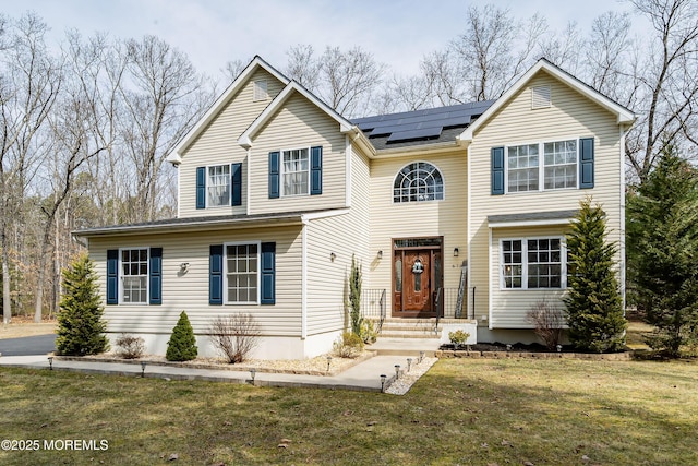 traditional home featuring solar panels and a front lawn