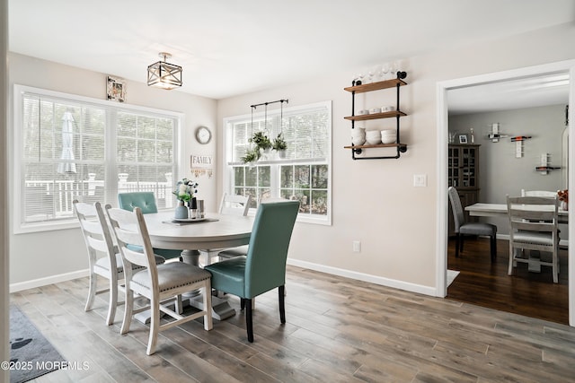 dining area featuring baseboards and wood finished floors