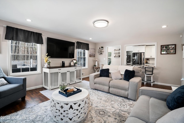 living room with recessed lighting, baseboards, and wood finished floors