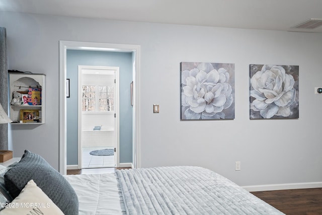 bedroom featuring visible vents, wood finished floors, and baseboards