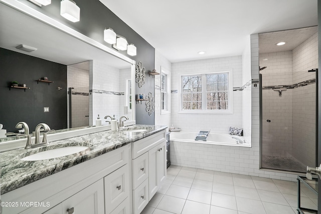 bathroom featuring a sink, a bath, a shower stall, and tile patterned flooring