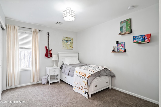 carpeted bedroom featuring visible vents and baseboards