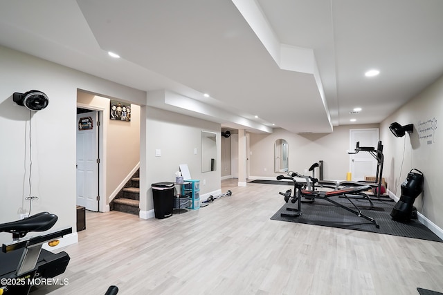 exercise room with recessed lighting, light wood-type flooring, and baseboards