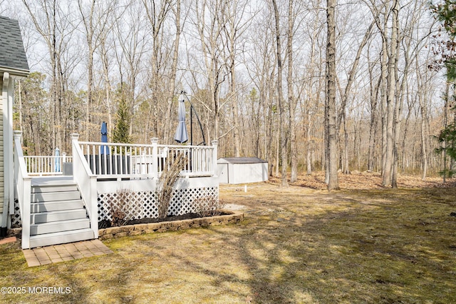 view of yard with an outbuilding, a storage unit, and a deck