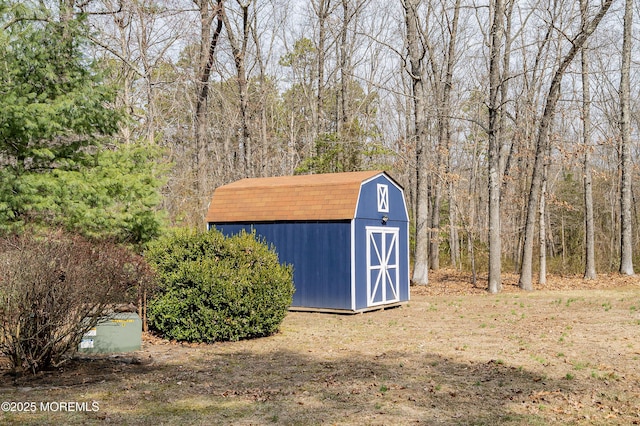 view of shed featuring a view of trees