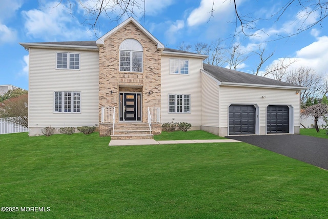 view of front of home with driveway, a garage, and a front lawn