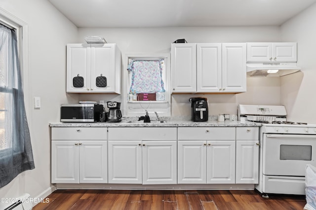 kitchen featuring stainless steel microwave, white cabinetry, a sink, white range with gas stovetop, and under cabinet range hood