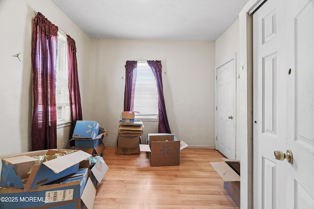 bedroom with multiple windows and wood finished floors