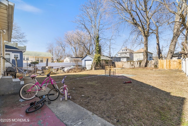 view of yard featuring a fenced backyard and a residential view