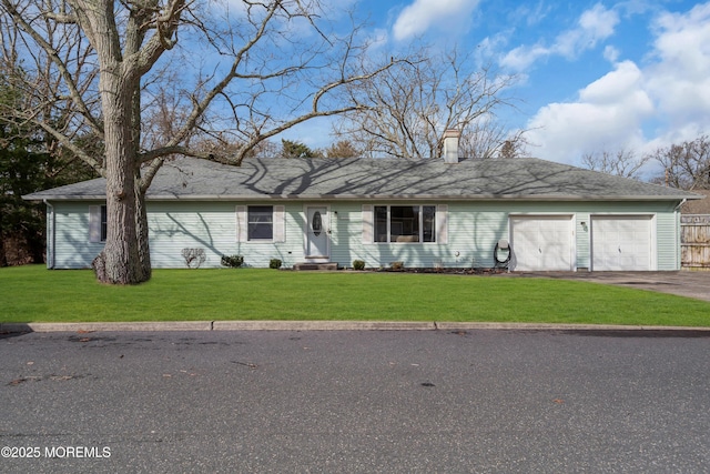 ranch-style house featuring a garage, aphalt driveway, a chimney, and a front yard