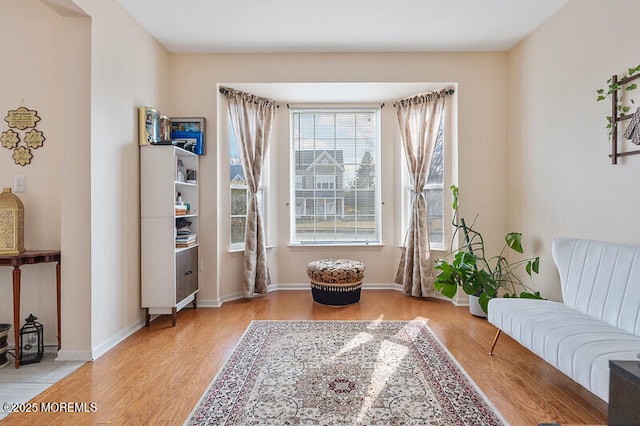 sitting room featuring baseboards and wood finished floors