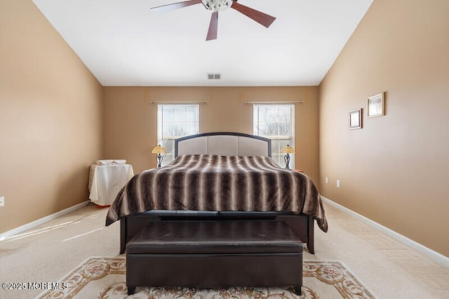 carpeted bedroom featuring a ceiling fan, visible vents, vaulted ceiling, and baseboards