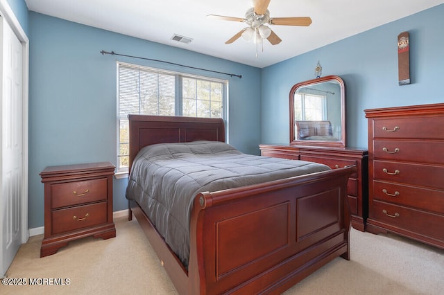 bedroom featuring visible vents, multiple windows, light carpet, and baseboards