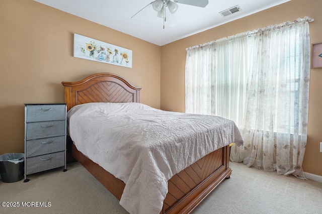 bedroom with ceiling fan, visible vents, and carpet flooring