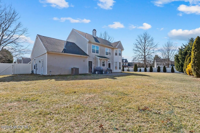 back of property featuring a yard, central AC unit, a fenced backyard, and a gate