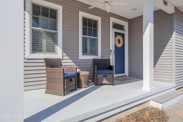 view of exterior entry with a porch and ceiling fan