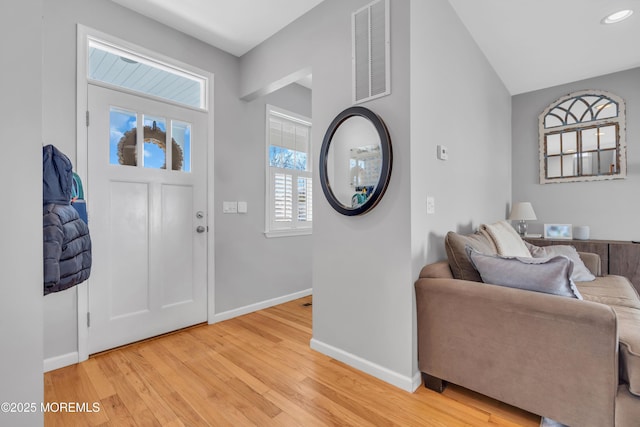 foyer featuring light wood-style flooring, visible vents, baseboards, and recessed lighting