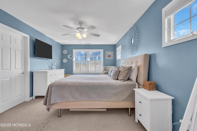 bedroom with ceiling fan, visible vents, and light colored carpet