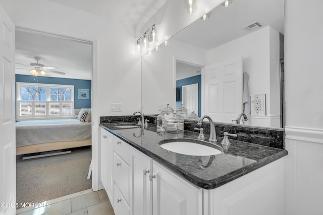 bathroom with ensuite bath, visible vents, a sink, and wainscoting