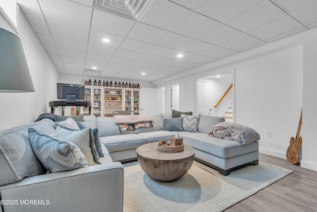 living room with recessed lighting, wood finished floors, visible vents, and baseboards