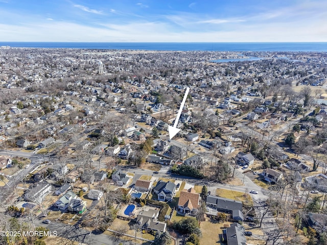 drone / aerial view with a water view and a residential view