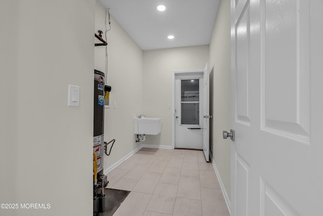 bathroom featuring water heater, recessed lighting, tile patterned flooring, and baseboards