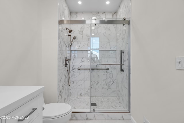 bathroom featuring marble finish floor, a marble finish shower, recessed lighting, toilet, and vanity