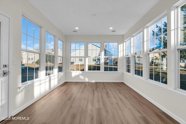 unfurnished sunroom featuring visible vents and a wealth of natural light