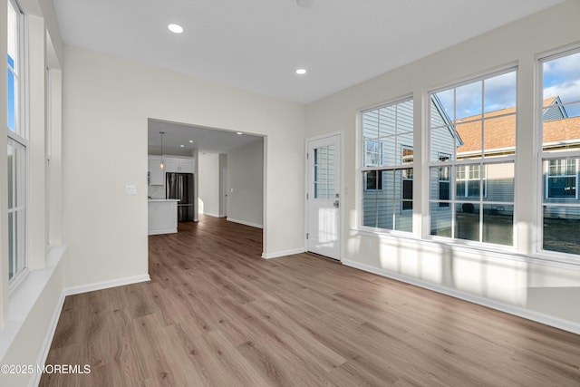 unfurnished room featuring baseboards, recessed lighting, and light wood-style floors