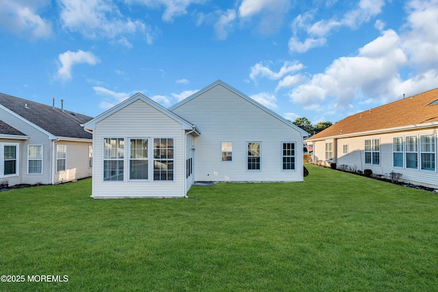 rear view of property with a yard